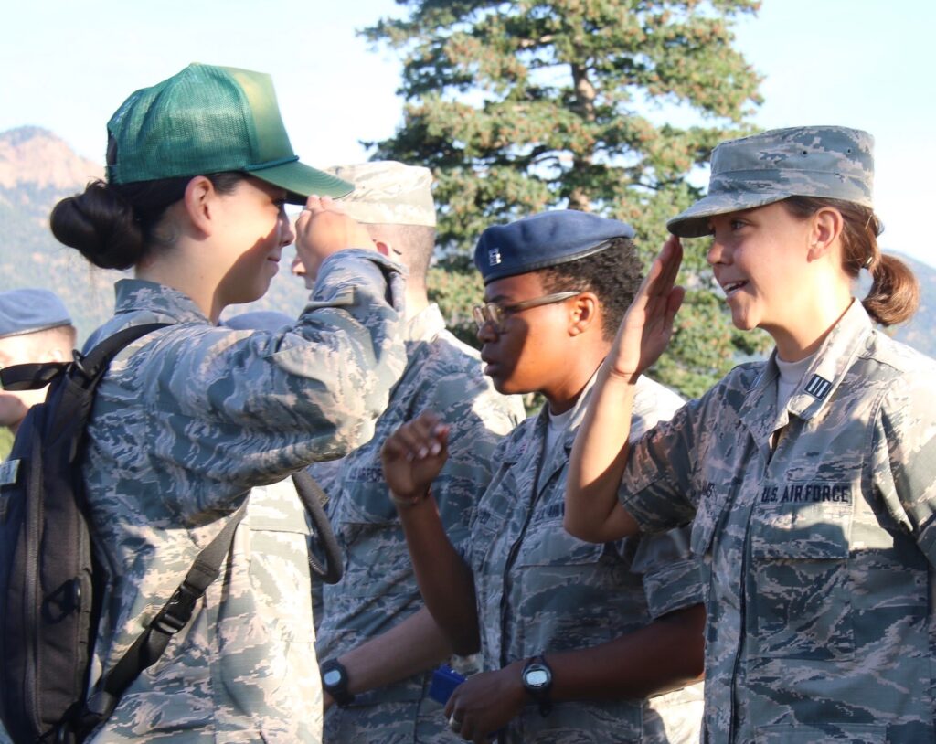 A cadet acting as a USAFA Preparatory BMT Instructor saluting one of her leaders. 